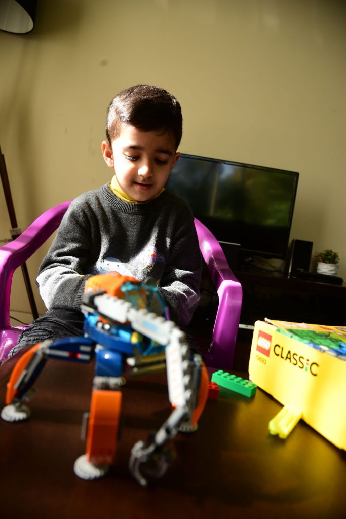 Boy playing with Lego blocks