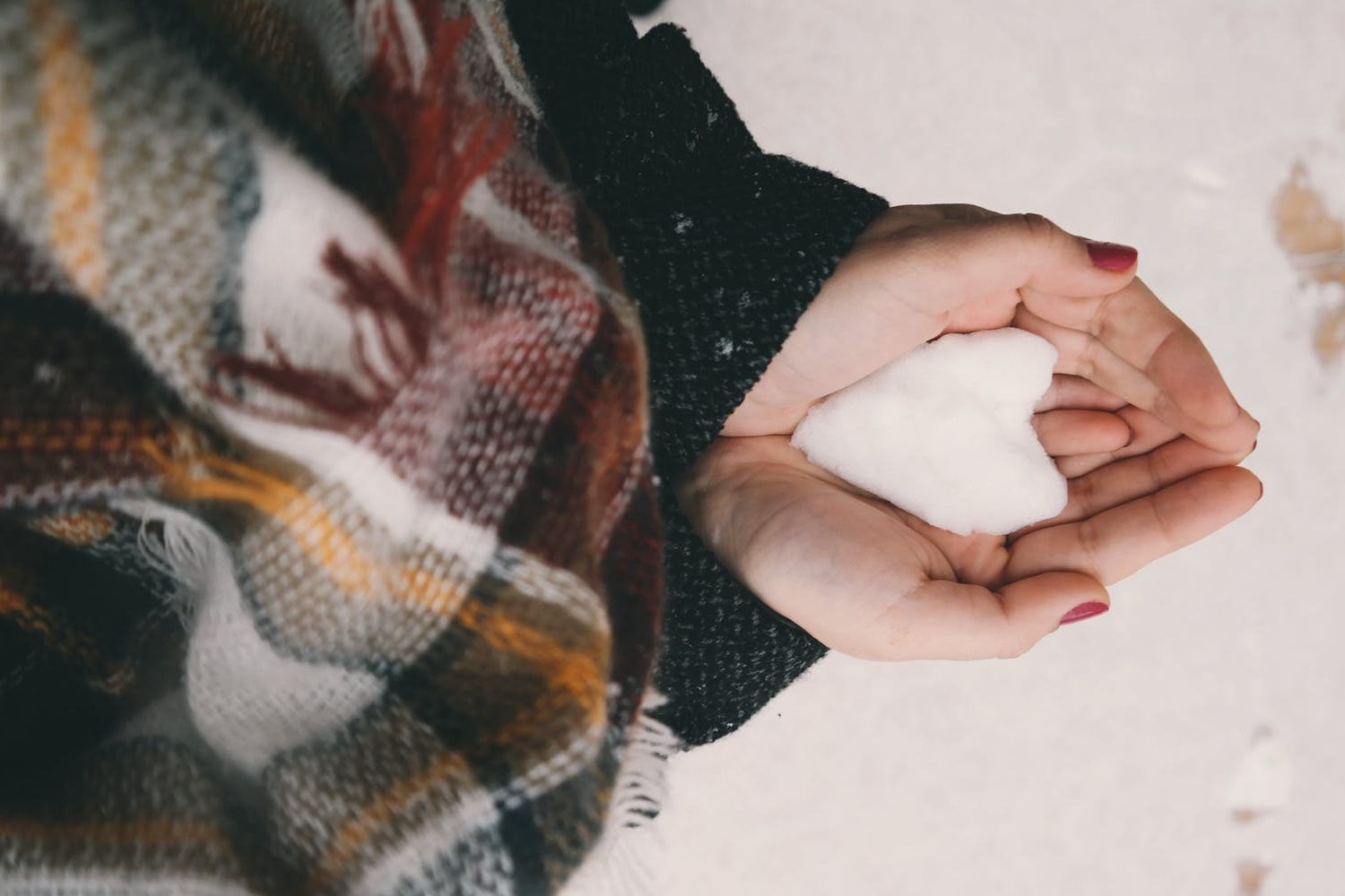Women standing in a snowfall - Winter care tips for new mothers