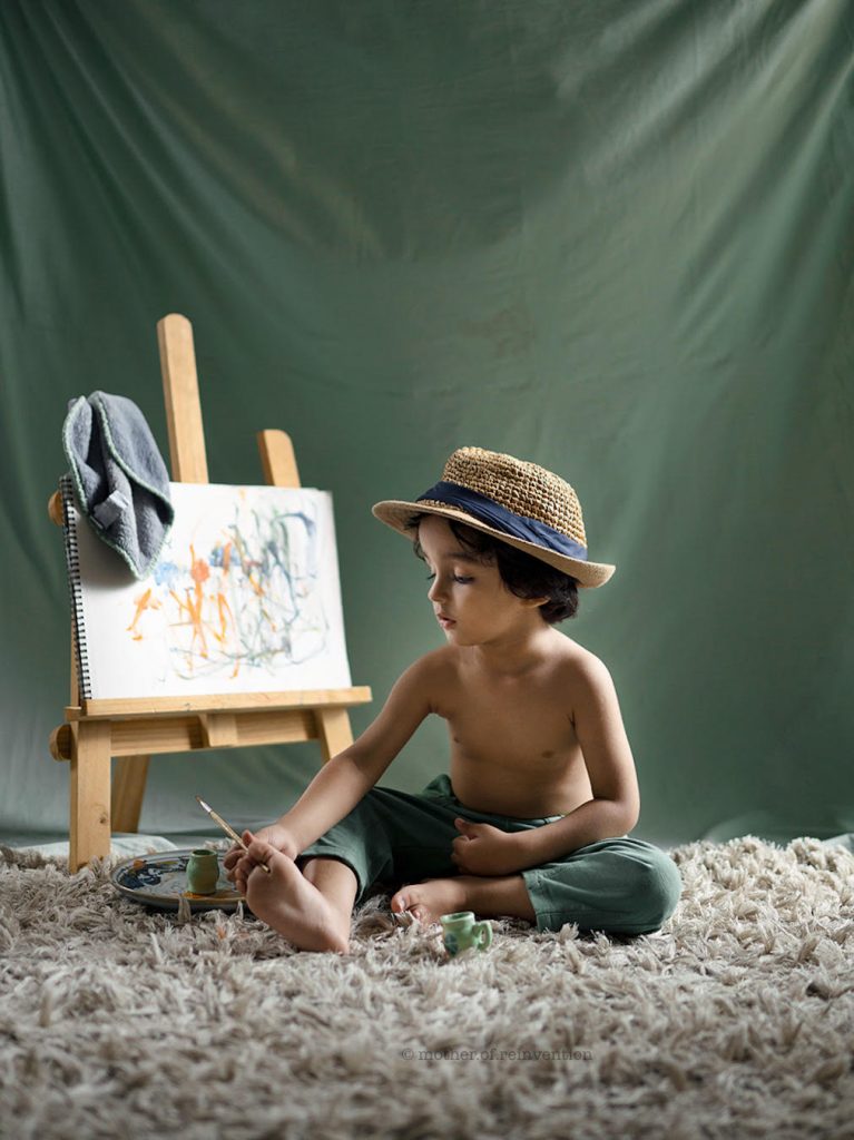 a boy painting on the canvas