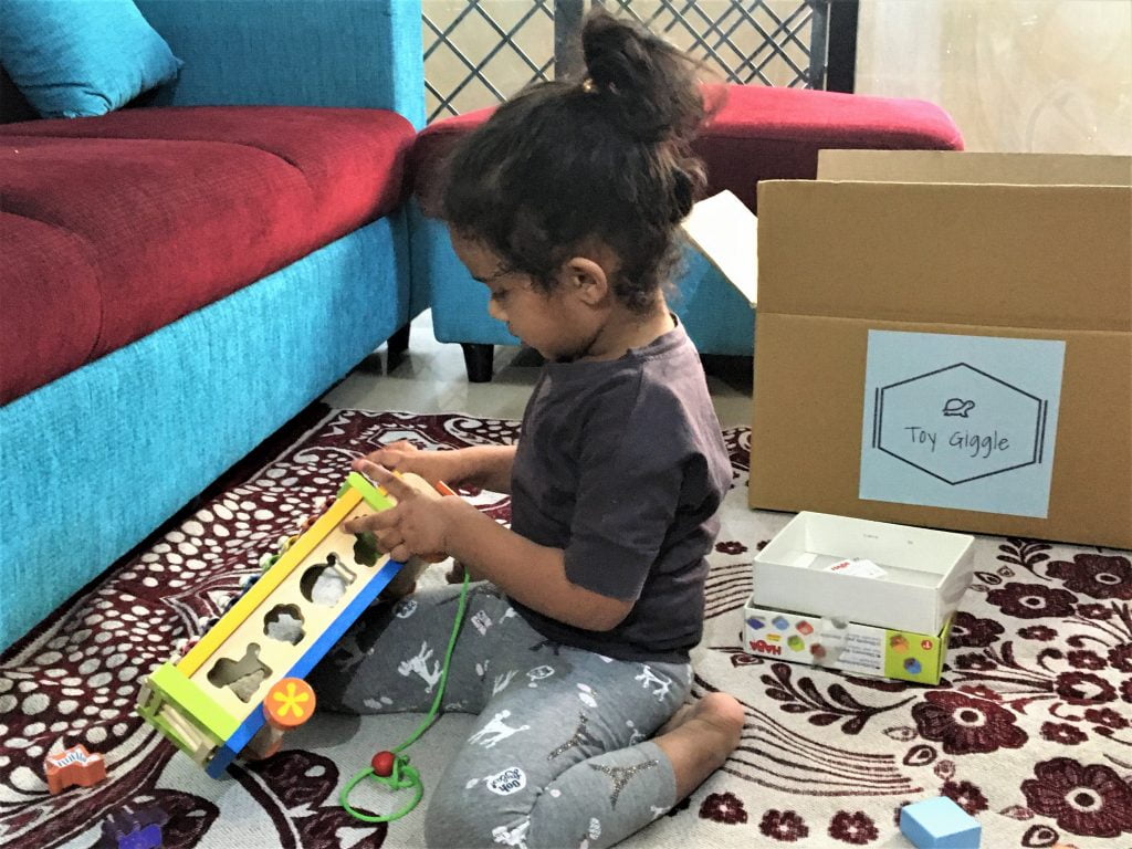 A girl playing with Toy Giggle toys