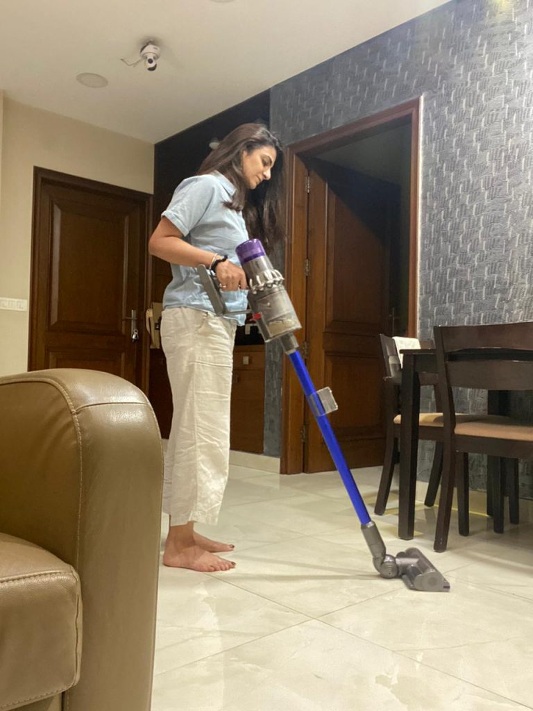 Vacuum cleaner at home - Woman cleaning her home