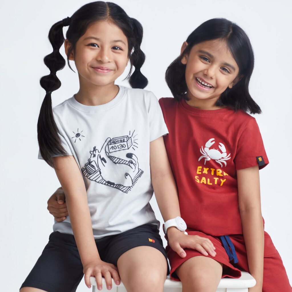 Two girls wearing Kiggle organic clothes